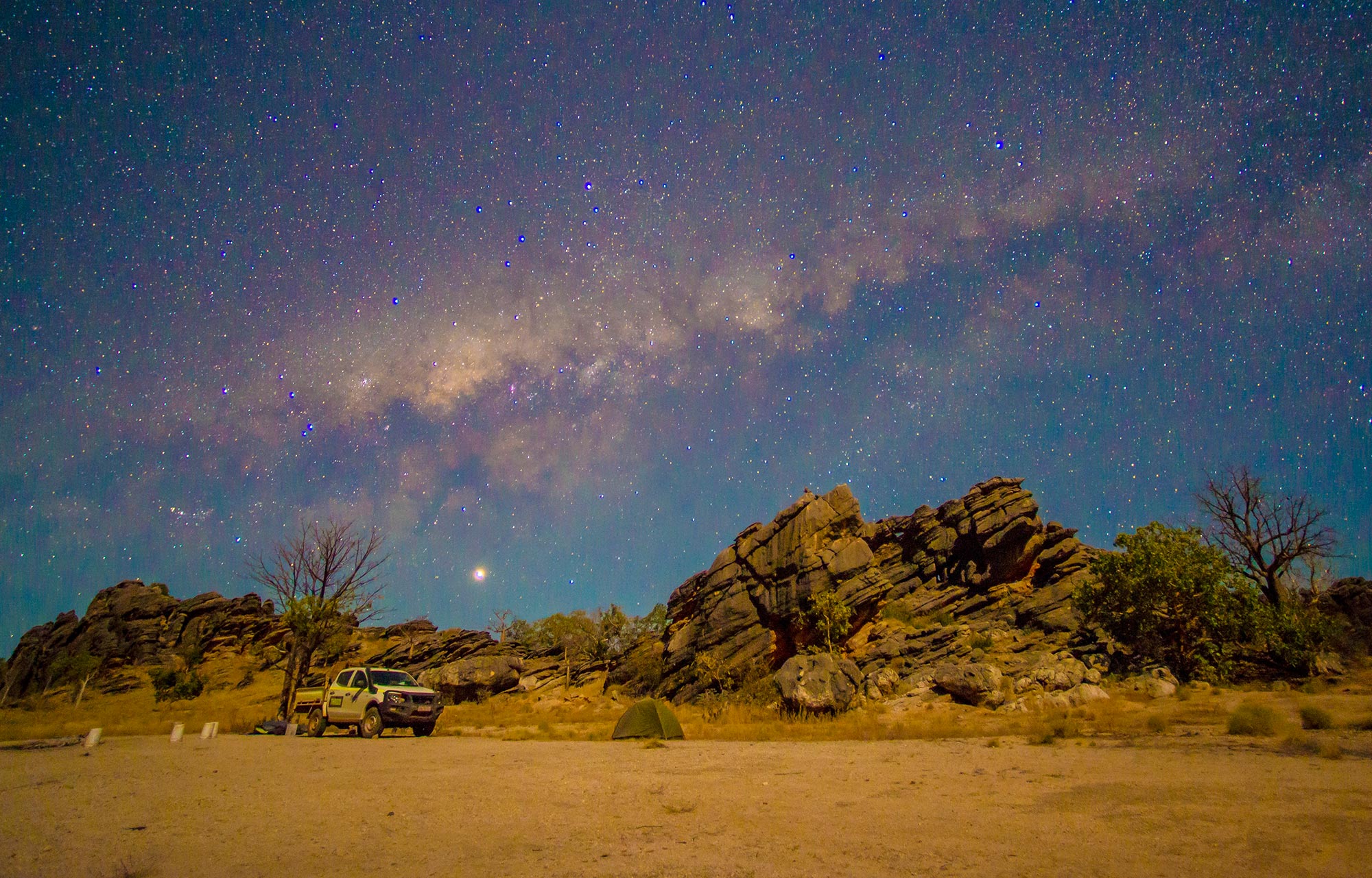 [a truck in the deset under the milky way]