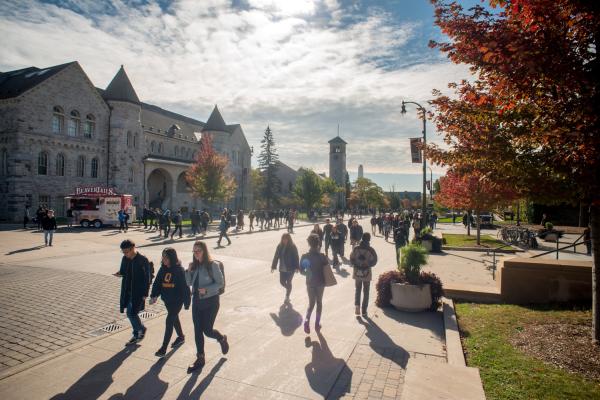 Students walking on campus, long shadows