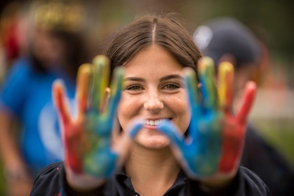 Smiling Student with painted tri-colour hands