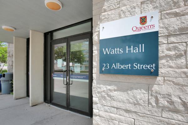 Watts Hall sign by exterior entrance.