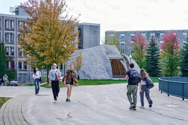 Students walk by the Outdoor Indigenous Gathering Space on a fall day.
