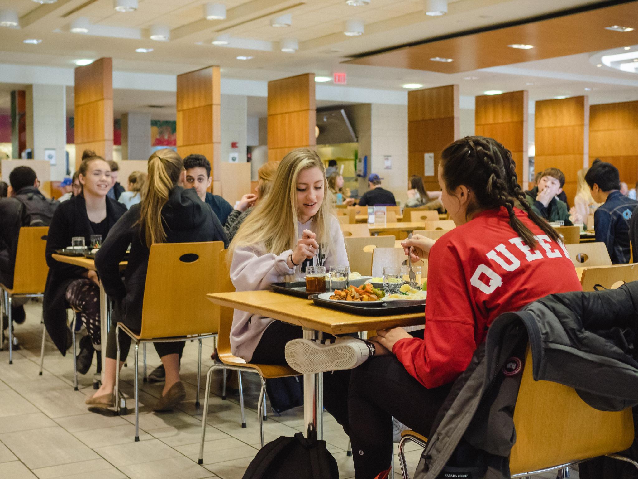 Students sitting in Leonard Dining Hall eating.