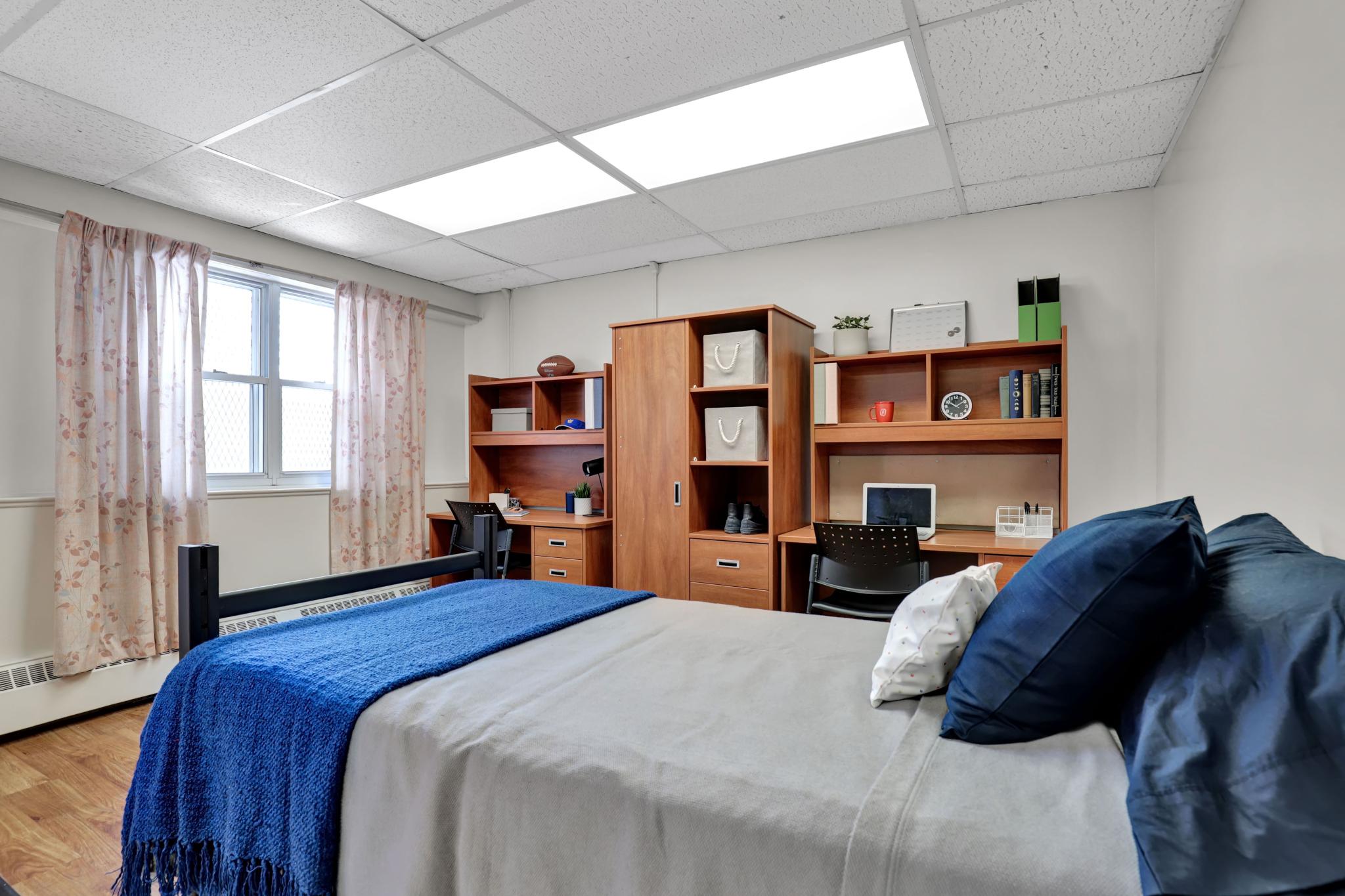 Single bed in a double occupancy room in Jean Royce Hall residence. 