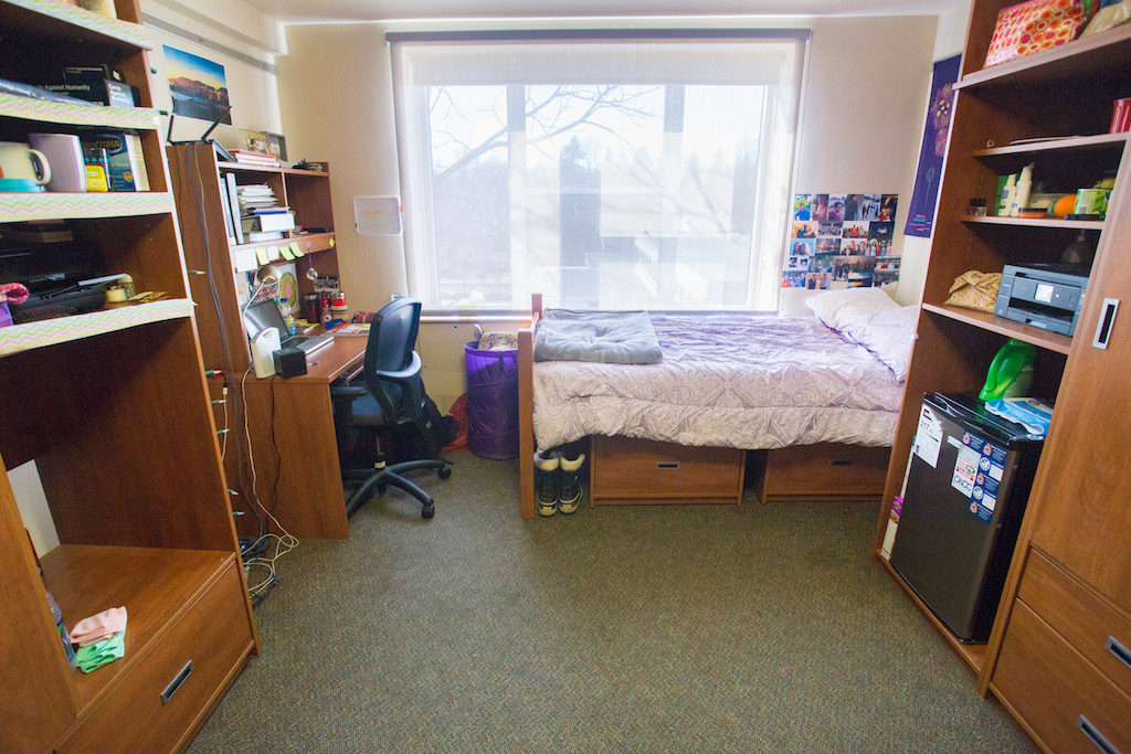 Inside of a double room in McNeill House. Two wardrobes, one desk and a bed are in view. 