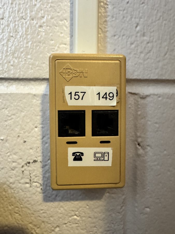 Tan surface-mounted box with two jacks; one has a computer icon