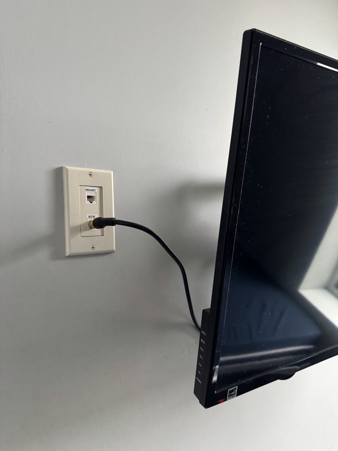 Wall plate with a network jack on the left and a round TV coax connector