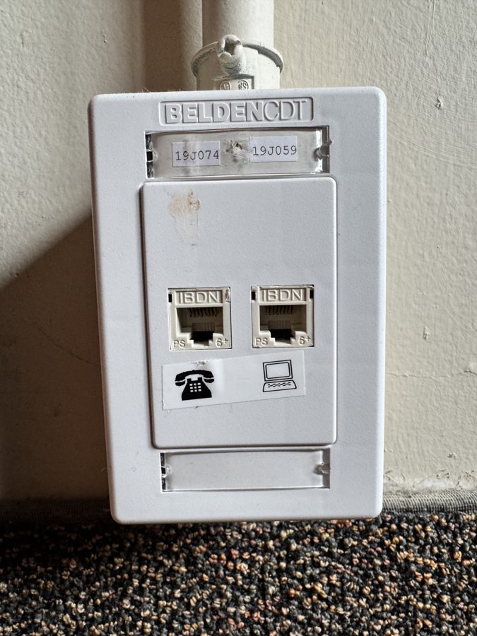White surface-mounted box with two jacks; one has a computer icon