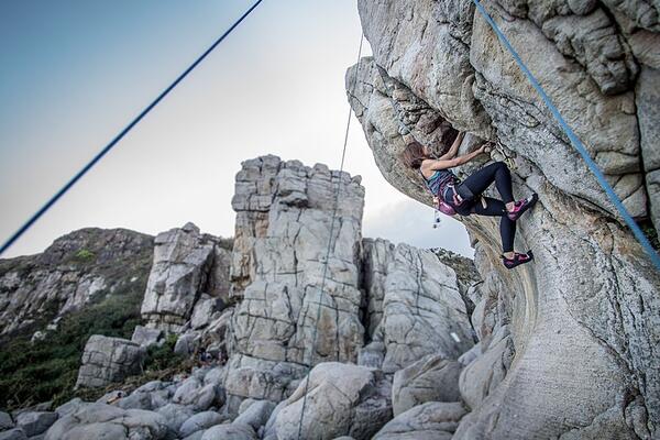 Woman rock climbing on cliff
