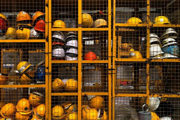 Metal cages with hard hats in them