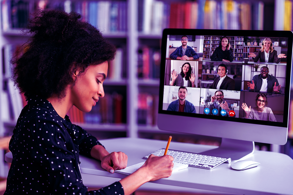 Person in front of computer with 9 colleagues online virtually