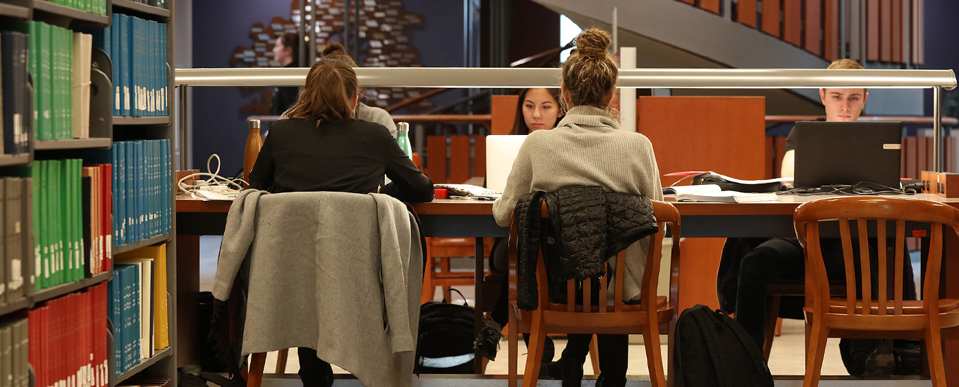Students sitting at a table in the library