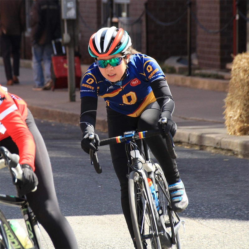 A Queen's athletics student cycling