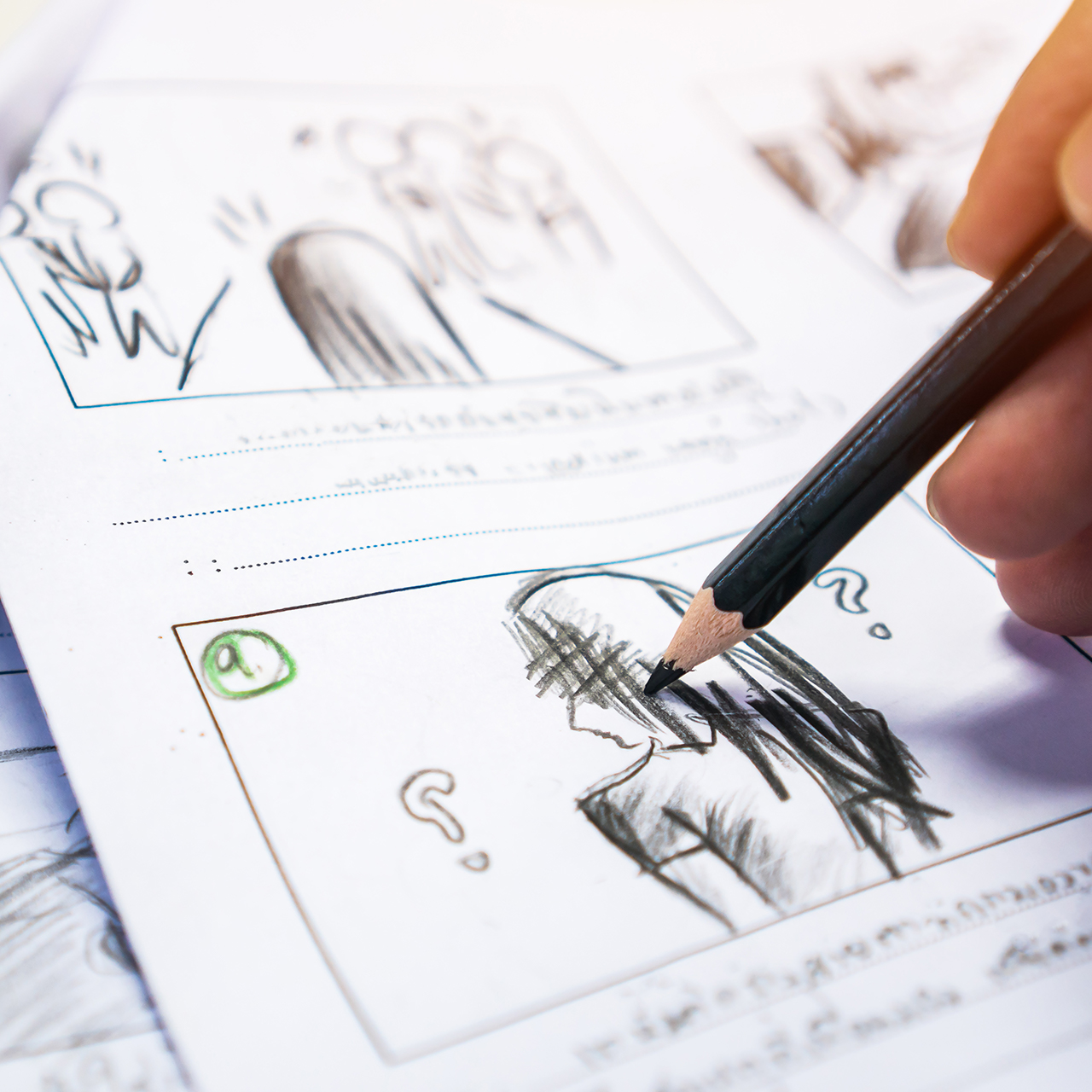 A hand drawing out a storyboard