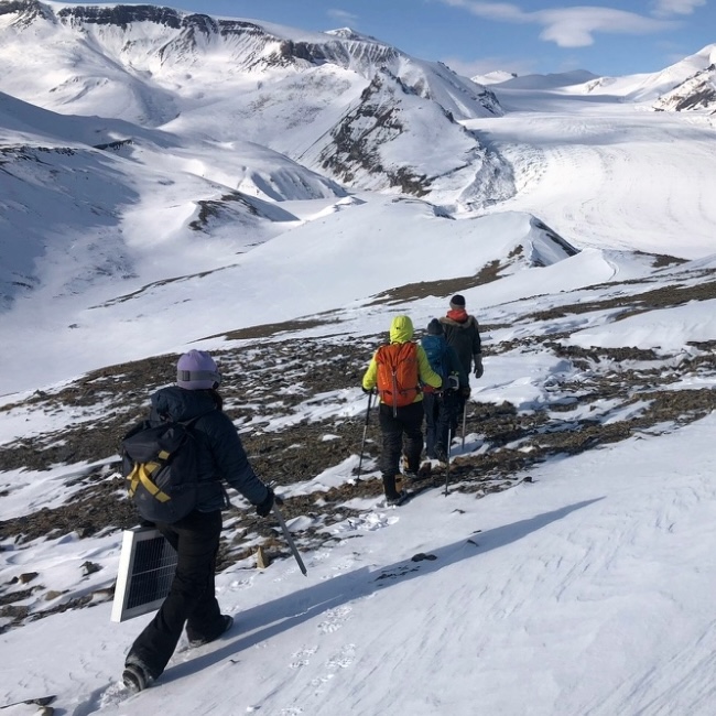 Researchers hiking on a snowy mountain