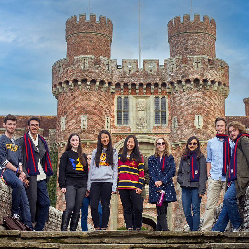 Queen's students standing in front of Herstmonceux Castle at Bader College