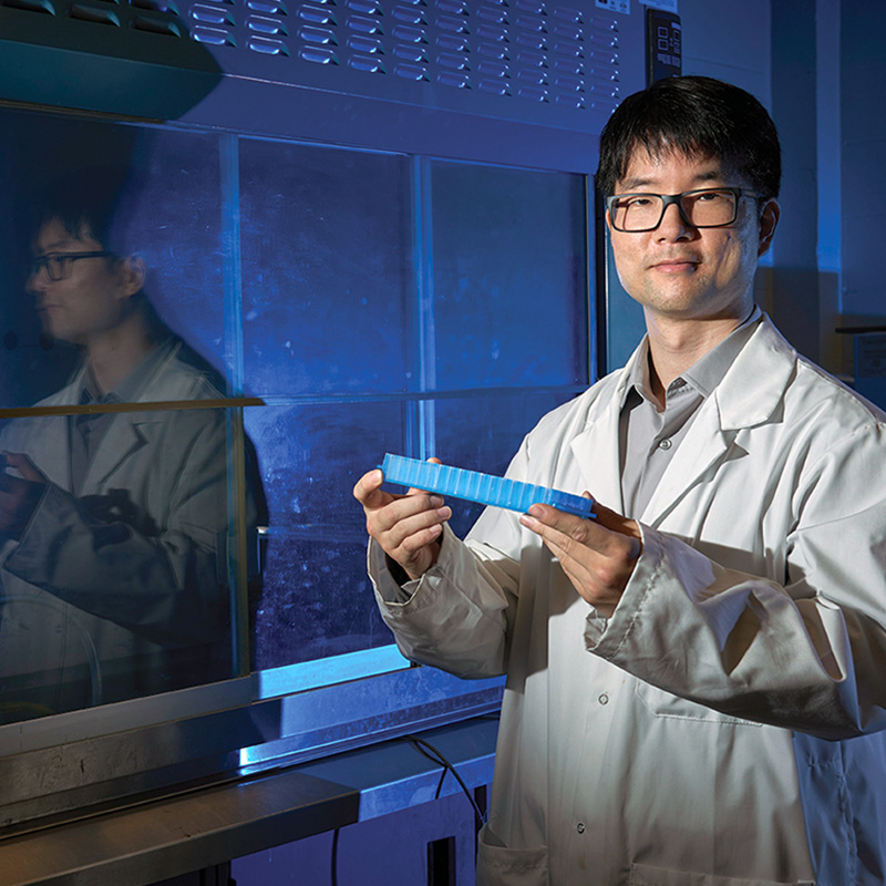 Professor holding plastics research