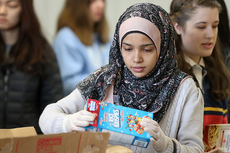 [Photo of a student volunteering at the AMS Food Bank]