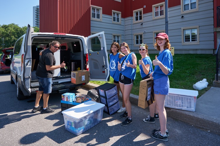 [Volunteers help students move out of Queen's residence buildings]