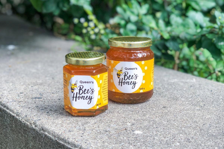 [Two jars of Queen’s Bee Honey.]