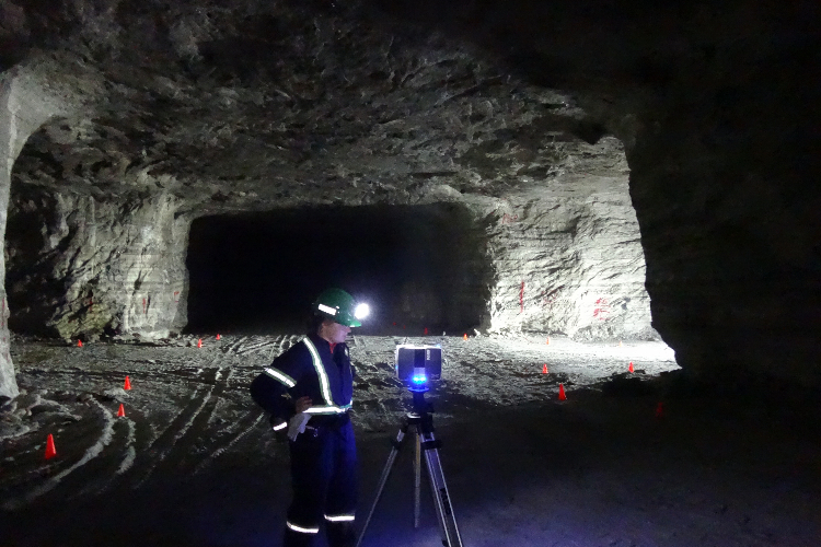 [A student conducting a scan with a laser in an underground salt cavern in Windsor, Ontario.]