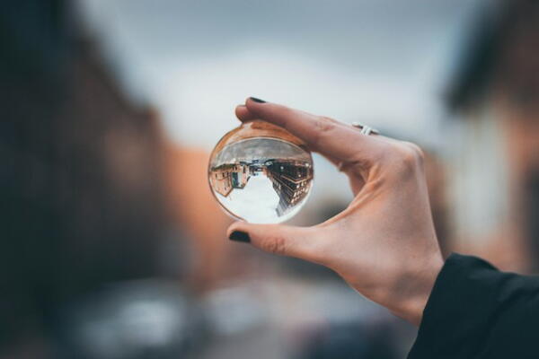 Person holding a glass orb