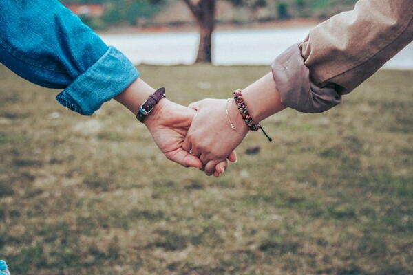 Two people holding hands
