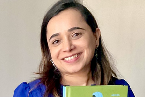 Fauzia Husain holding her published book. 