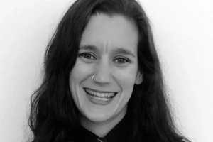 Nicole Myers smiling in black and white photo. 