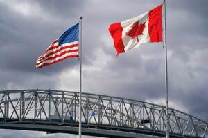 American flag flying beside a Canadian flag.
