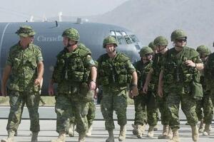 Canadian troops walk on the tarmac after disembarking from a military transport plane at Kabul international airport in Kabul, Afghanistan, in July 2003. Photo by APICHART WEERAWONG /Associated Press