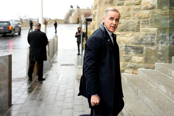 Mark Carney walking up stairs