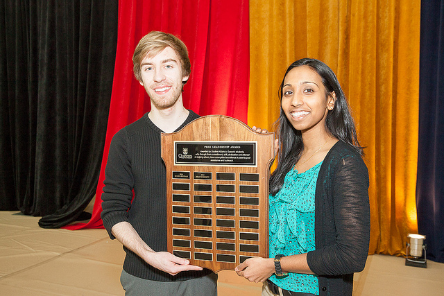 2014 Peer Leadership Award recipients Sean Doherty and Roopa Suppriah hold their plaque