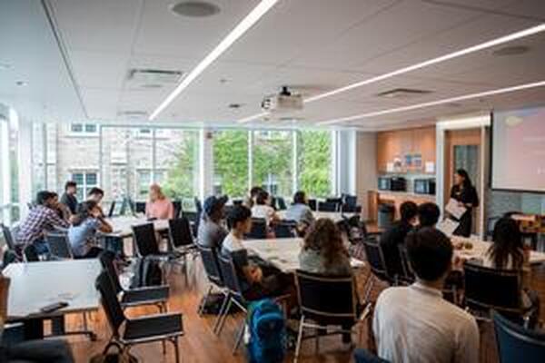 Students gathered learning in a classroom facing the front 