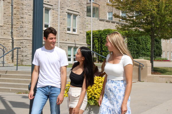 3 students chatting outside