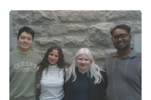 four students against brick wall