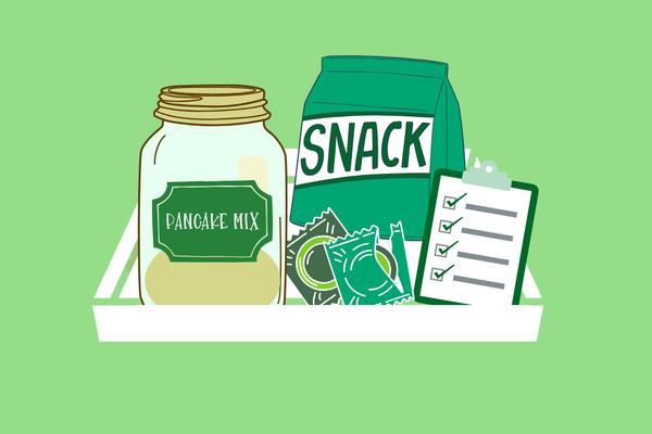 trey with pancake mix, snacks, checklist and condoms