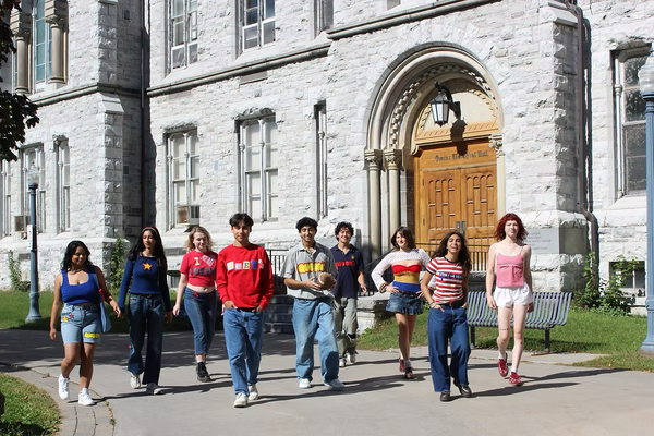 QSFS members wearing up-cycled items outside a university building 