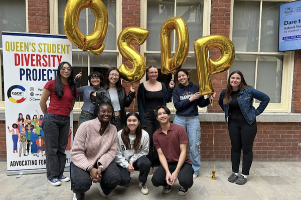 Students gathered infront of banner and balloons