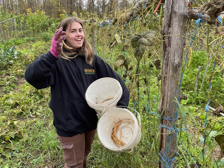 Lauren happy with her bean seed harvest