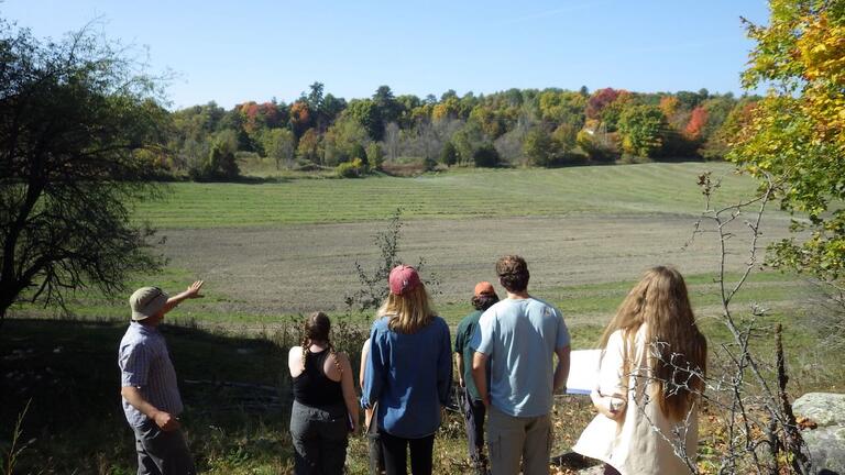 Charles Summers explaining the complex process of inserting tile drainage in the sub-soil of the field in the background to reduce the risk of spring/early summer flooding