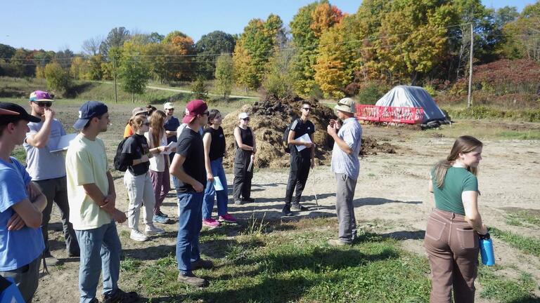 Charles Summers of Salt of the Earth farm extolling the virtues of the cow manure pile to his right!