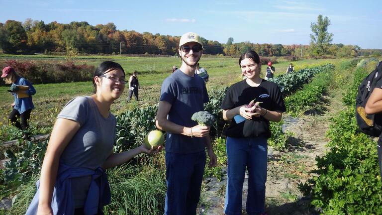 students showing off harvested crops