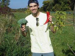 Dylan very happy with his harvest of broccoli and peppers