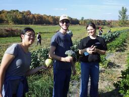 students showing off harvested crops