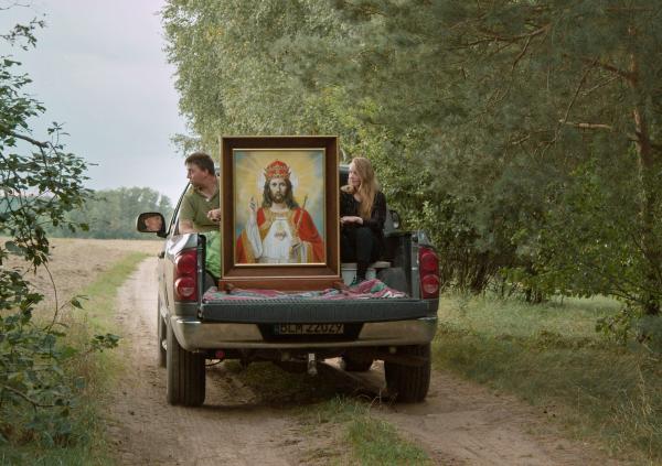 A portrait of Jesus Christ is carried in the back of a truck