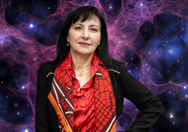Prof Marcella Carena poses in front of a glittering galaxy