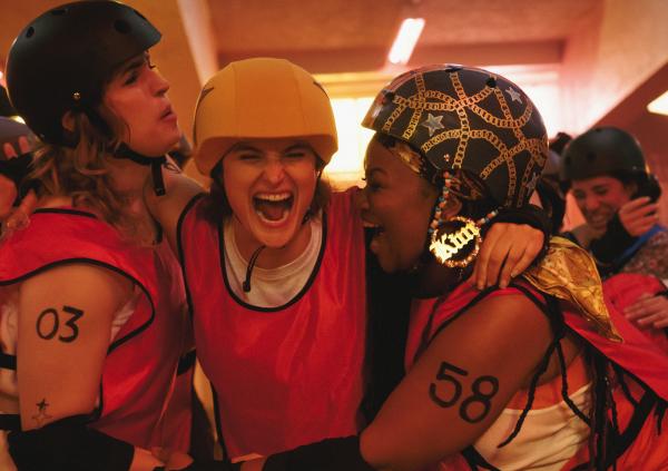 Roller derby players cheer in triumph