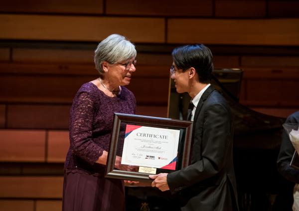 Margaret Foster shaking hands with Jonathan Mak