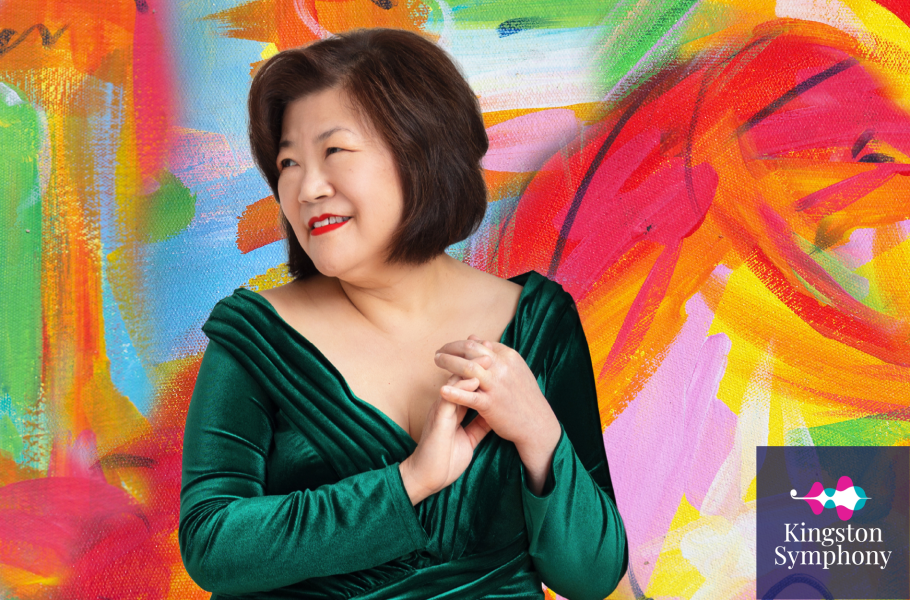 Angela Cheng poses in front of a multicoloured painted background
