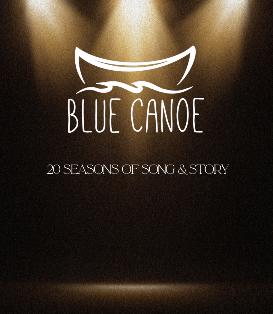 The blue canoe logo dramatically lit by spotlights